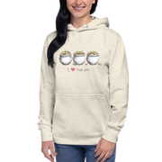 Woman wearing cream hoodie with 'I ❤️ triple pots' graphic, featuring three pots of gold coins, slot-themed apparel