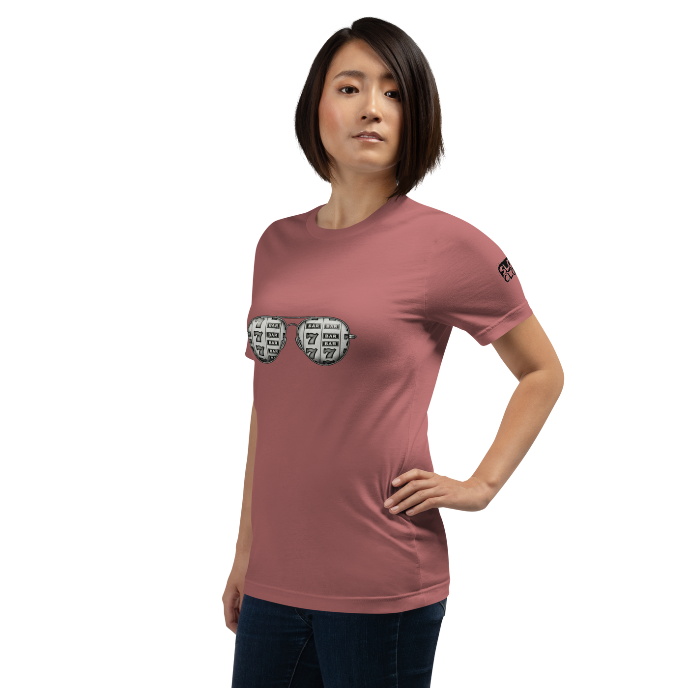 Woman wearing pink t-shirt with slot machine sunglasses graphic, featuring 7s and BAR symbols for casino-themed apparel