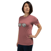 Woman wearing pink t-shirt with slot machine sunglasses graphic, featuring 7s and BAR symbols for casino-themed apparel